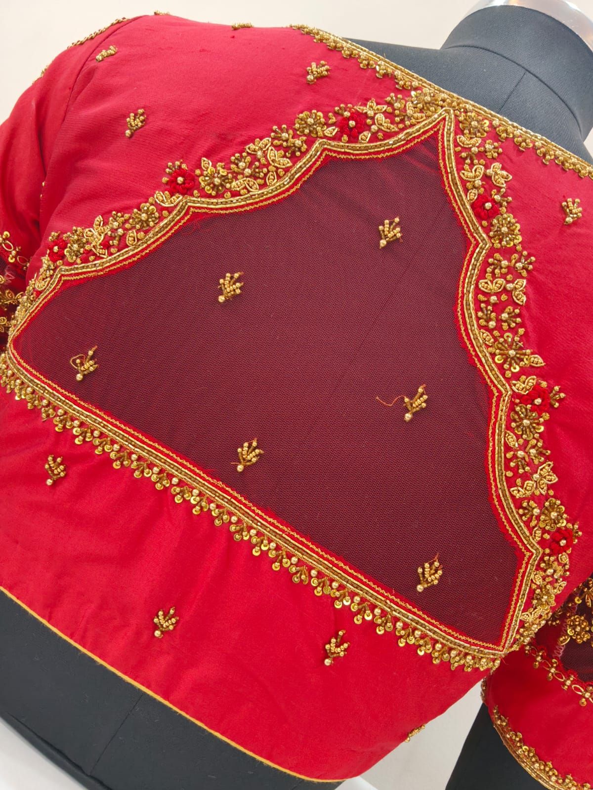 Close-up of gold beadwork scallops around a net panel