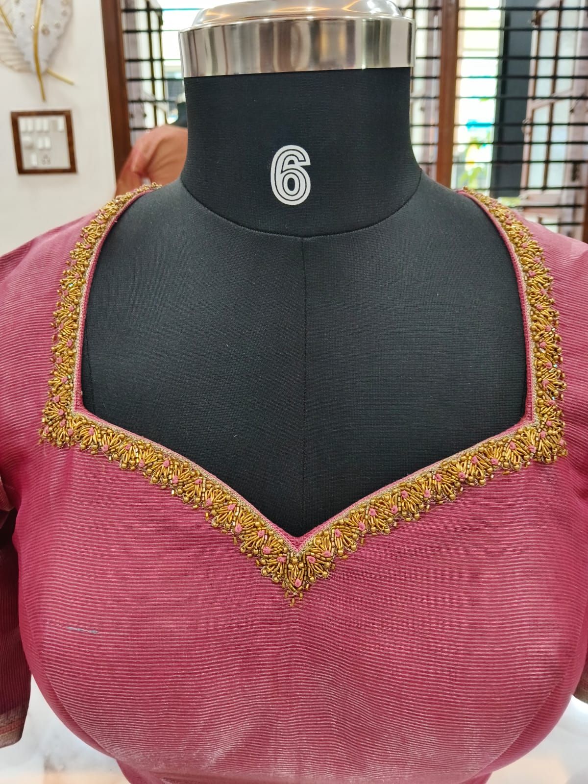 Rose tissue-silk blouse with a sweetheart neckline traced in gold beadwork