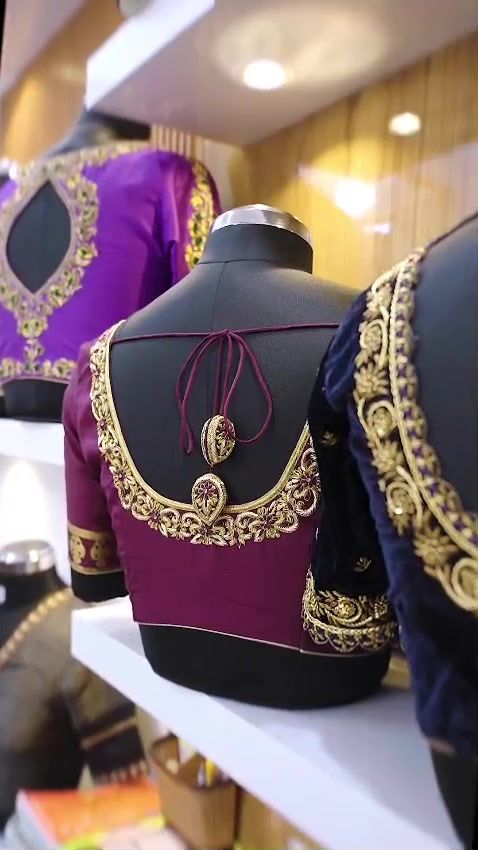 Embroidered blouses displayed on dress forms in the SLB studio